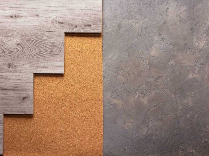 Laminate wood floor at cork background texture. Wooden laminate floor and corkboard on cemen