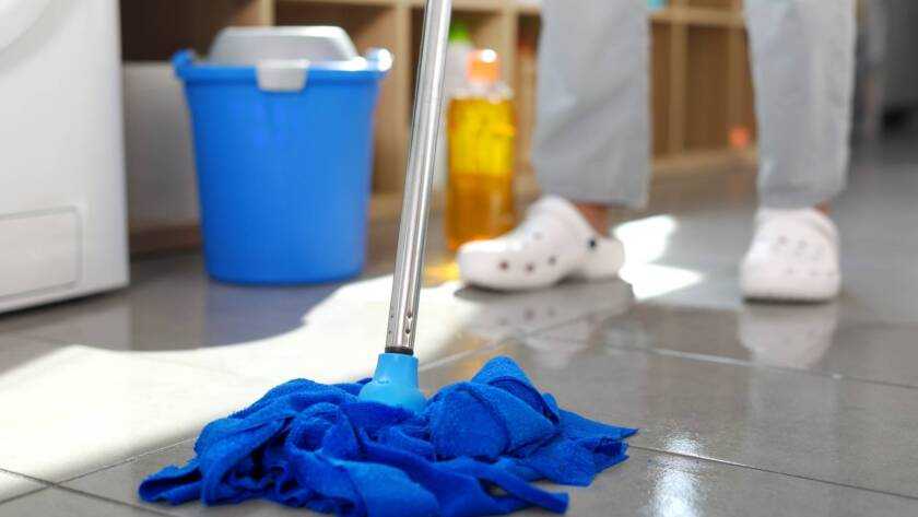 Woman washing floor at home